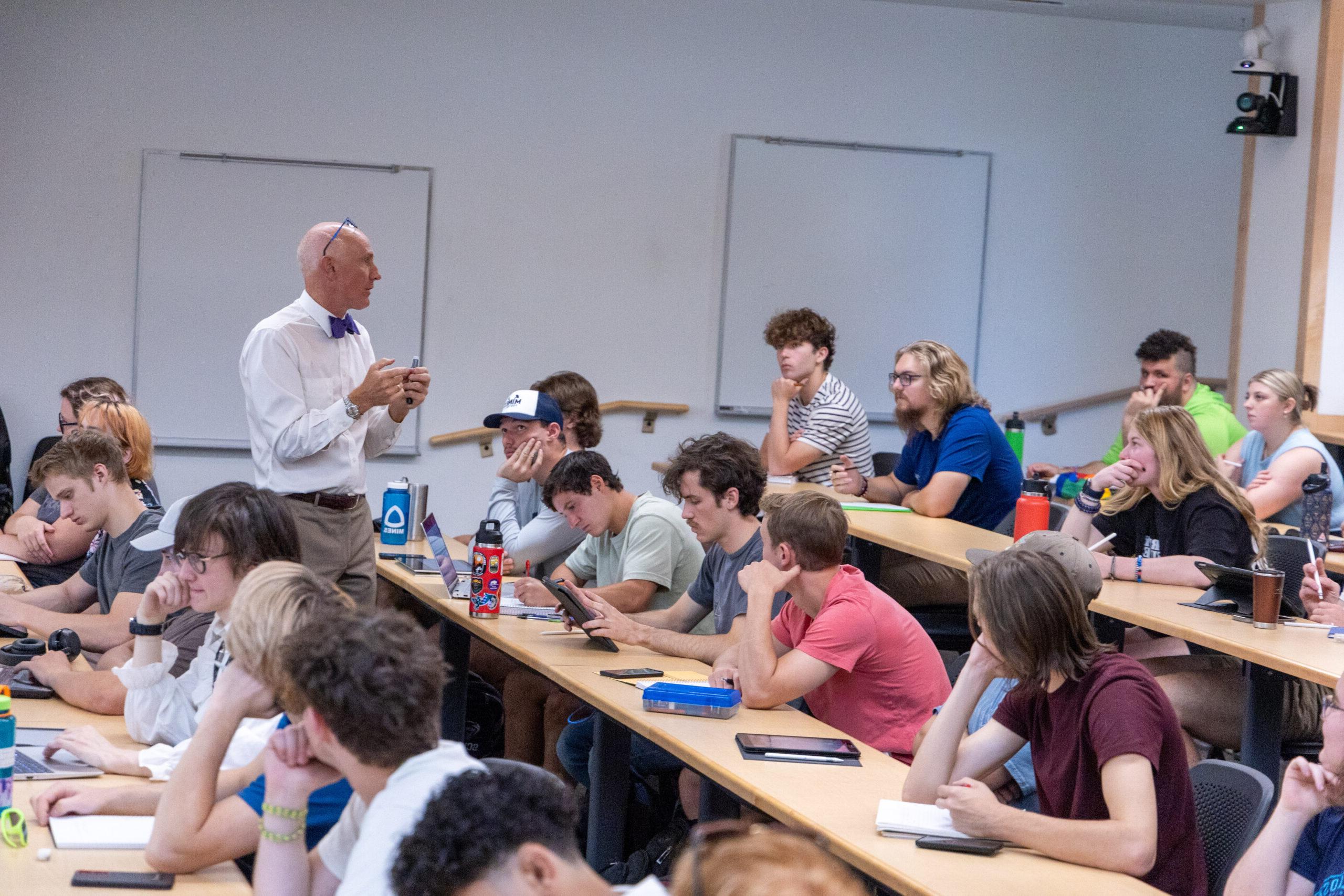 A professor teaching class in a lecture hall